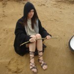 Hannah making a stick for writing